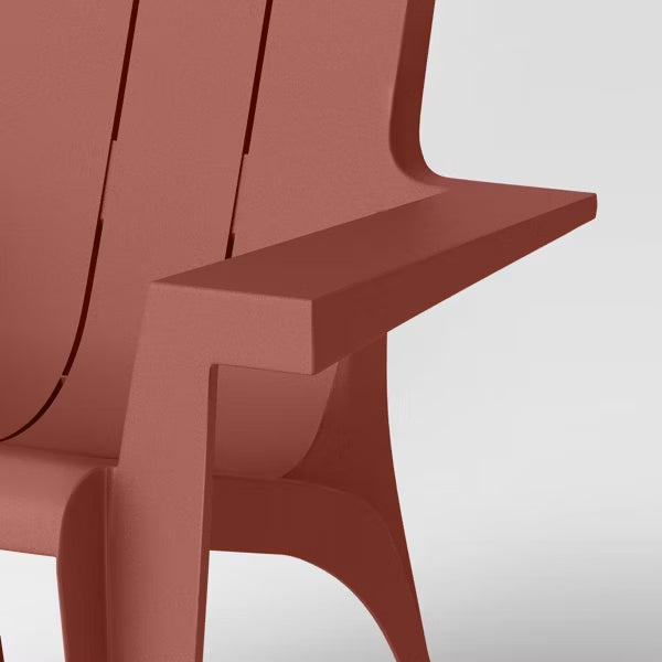 Close-up of a red Adirondack chair on a white background
